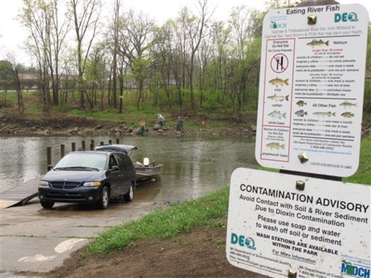 A sign posted along the Tittabawassee River near Midland, Mich., warns anglers to limit fish consumption because of dioxin contamination.